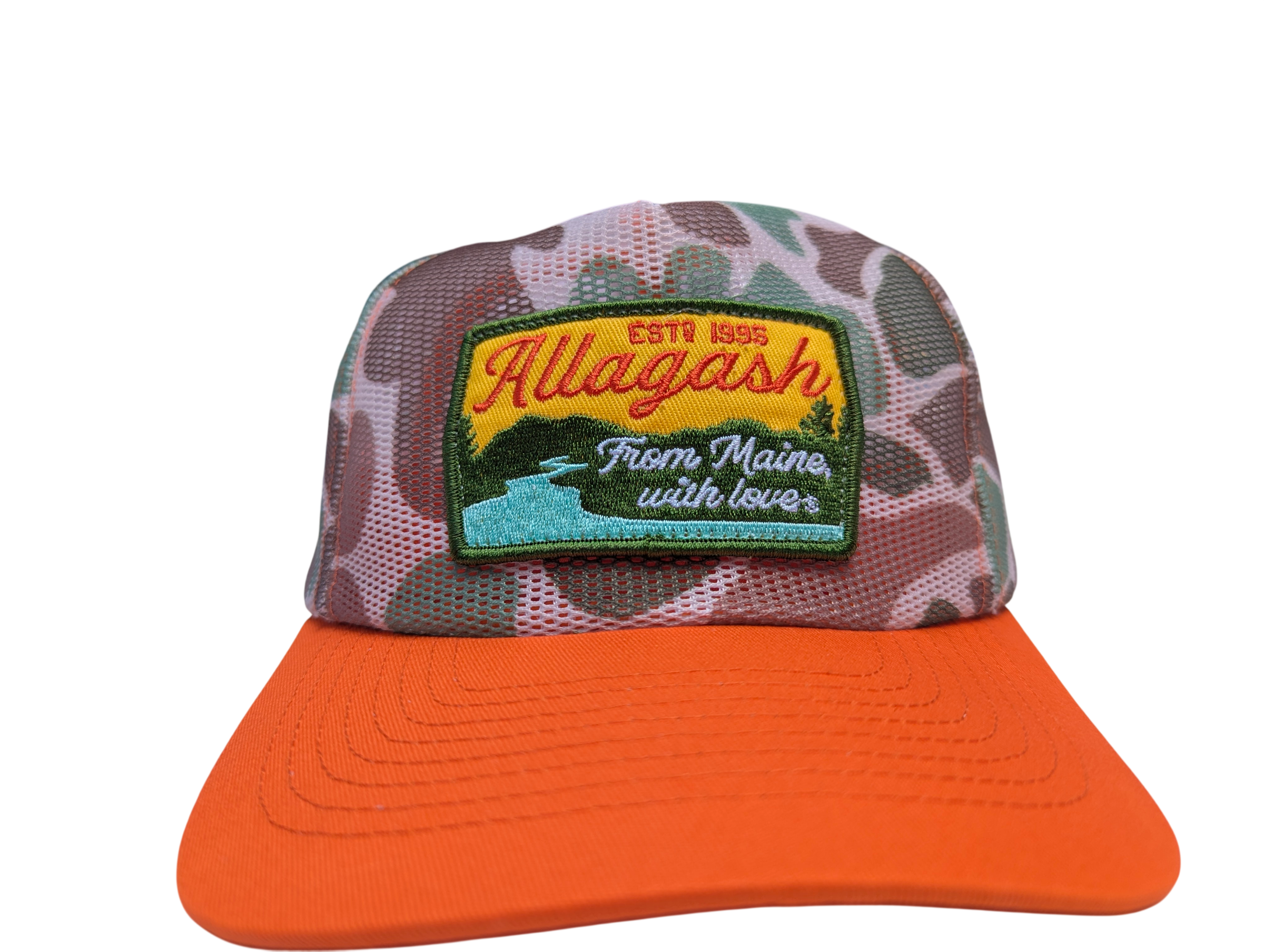 a mesh trucker hat with orange brim and camo colors. The front patch reads Allagash From Maine with love estd 1995
