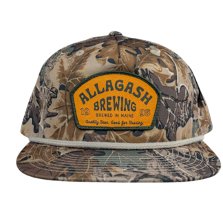 a camouflage hat with an orange patch that reads Allagash Brewing Company