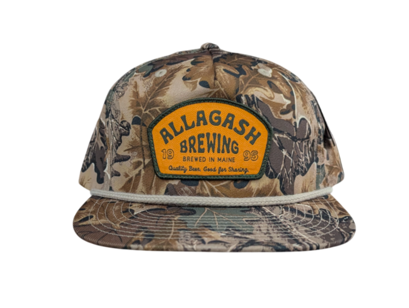 a camouflage hat with an orange patch that reads Allagash Brewing Company
