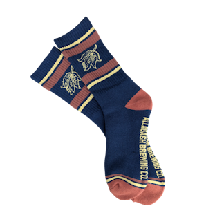 A pair of red and blue socks featuring a yellow leaf and the text Allagash Brewing Co.