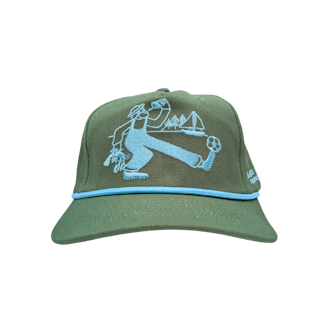A green canvas hat with an embroidered fisherman character kicking a soccer ball