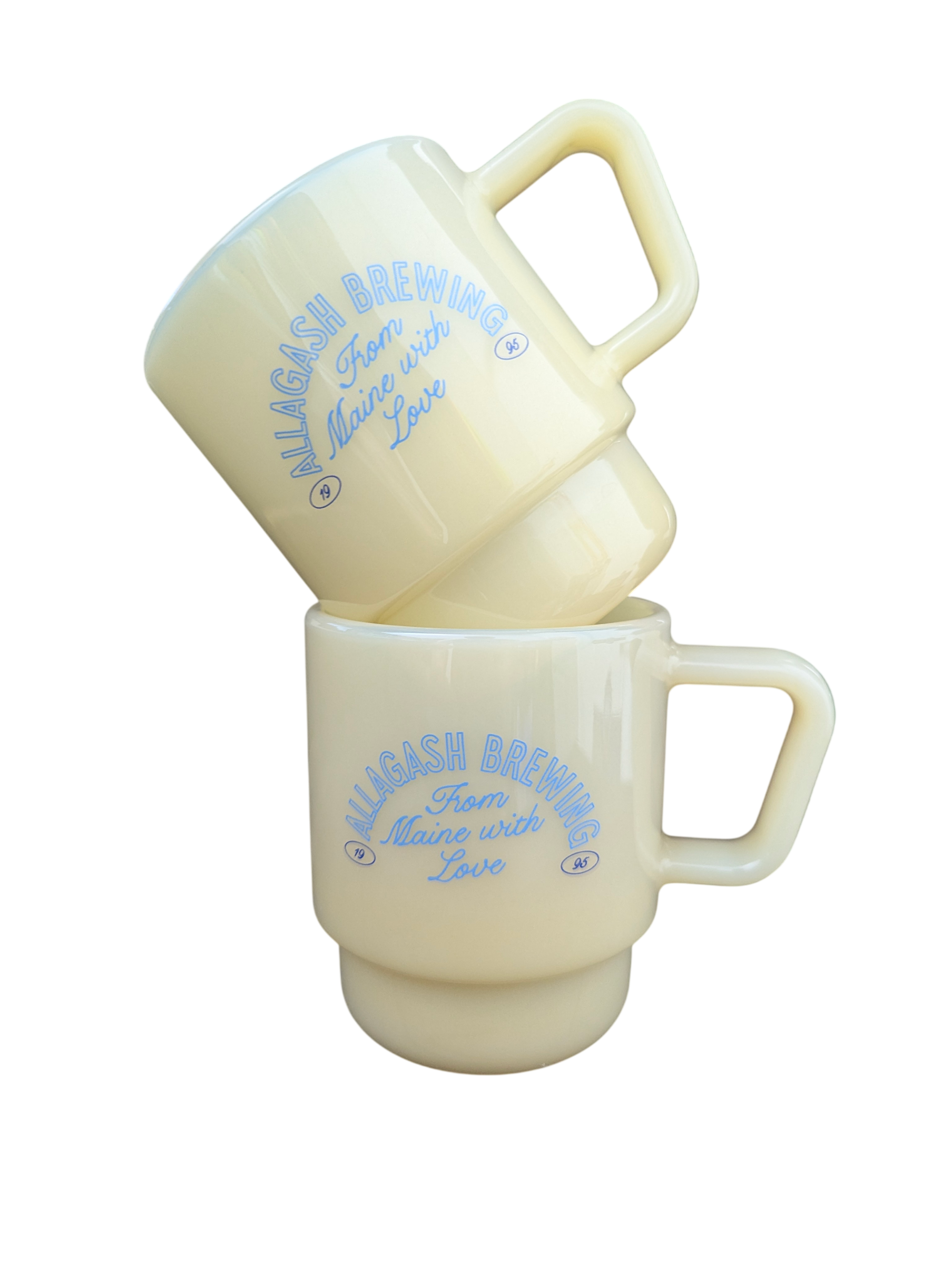 2 stacked milk-glass mugs with Allagash logo