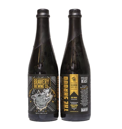 two bottles of The Shroud bourbon barrel-aged beer, the left bottle showing the front label art, the right showing the label details