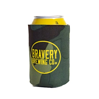 front of camo beer koozie in use with a yellow can peeking out of the koozie. Bravery Brewing's logo with a circle around it is printed in yellow on front of the koozie.