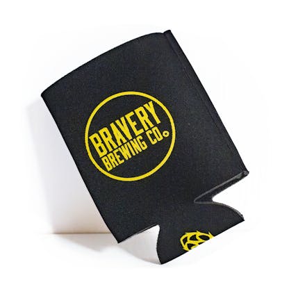 Front of black beer koozie. Bravery Brewing's logo with a circle around it is printed in yellow on front of the koozie. A beer hop is printed on the bottom of the koozie in yellow.