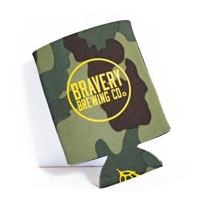 Front of camo beer koozie. Bravery Brewing's logo with a circle around it is printed in yellow on front of the koozie. A beer hop is printed on the bottom of the koozie in yellow.