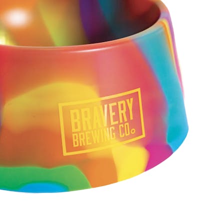 front detail of Rainbow Tie-Dye Dog Bowl with Bravery's logo printed in yellow