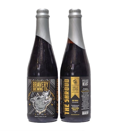 two bottles of The Shroud Vanilla bourbon barrel-aged beer, the left bottle showing the front label art, the right showing the label details