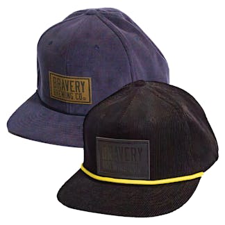 Photo showing the corduroy snapback in blue and black side by side on a white background.