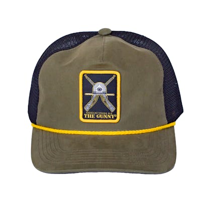Straight on photo of green trucker cap on a white background. The hat has green fabric for the front two panels and bill with black mesh for the back four panels. There is a white, grey and gold embroidered patch with art for the beer "The Gunny" across the front two panels. There is a yellow cord on the edge of the hat where the bill meets the cap.