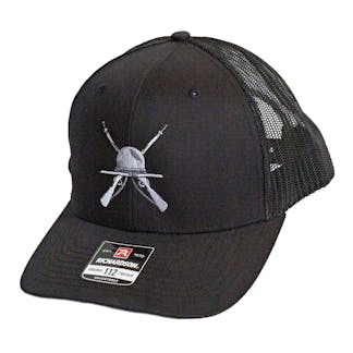 Front side photo of Black trucker cap on a white background. The hat has black fabric for the front two panels and bill with black mesh for the back four panels. There is a white and grey embroidered art for the beer "The Gunny" across the front two panels.