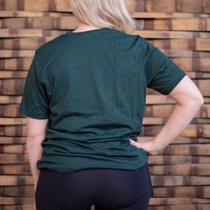 Photo of a person wearing a shirt facing away from the camera. The shirt is a dark heather green in color.