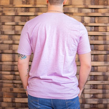 Photo of a person wearing a shirt facing away from the camera. The shirt is a light heather lilac in color.