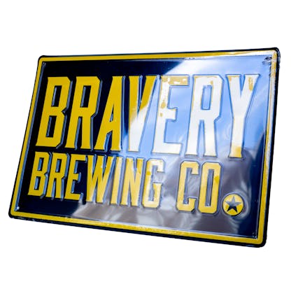 Photo of the tin tacker. the metal sign is at an angle and has the text "Bravery Brewing Co." embossed in yellow on a black background.