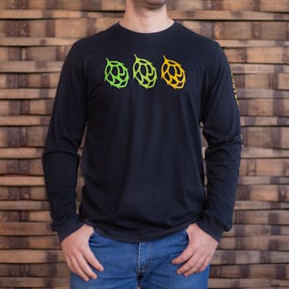 Photo of a person wearing a black long sleeve shirt from the front. The front of the shirt has the icons of three duplicate hops across the chest, from left to right they are vibrant green, light green, and yellow in color.